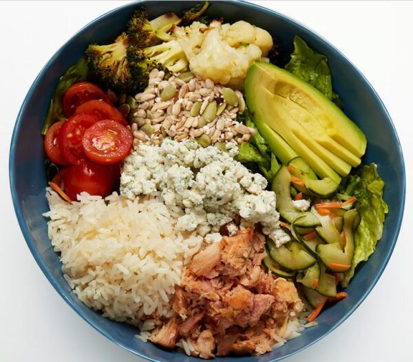 California Cobb Bowl Smoked chicken, avocado, roasted cauliflower, cucumber namasu, roasted broccoli, marinated cherry tomatoes, blue cheese crumbles, seed blend, your choice of grains with our greens blend and Greek dressing (served on side).