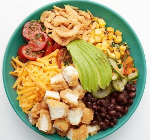 Fried Chicken Fried chicken tenders, avocado, roasted corn, marinated cherry tomatoes, black beans, cucumber namasu, cheddar cheese, crispy onions, your choice of grains with our greens blend and BBQ Ranch (served on side).